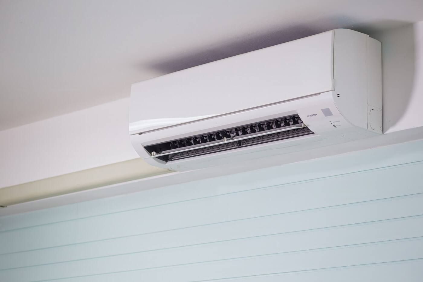 A ductless mini-split unit mounted high on a wall