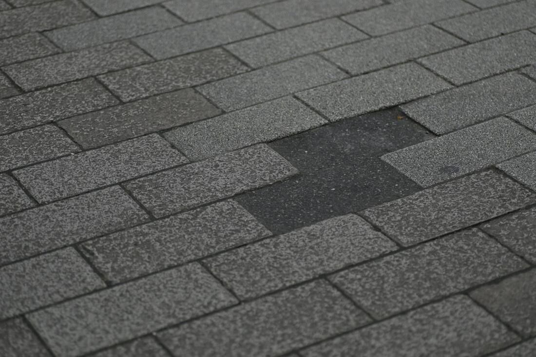 Close-up of an asphalt roof with one shingle missing